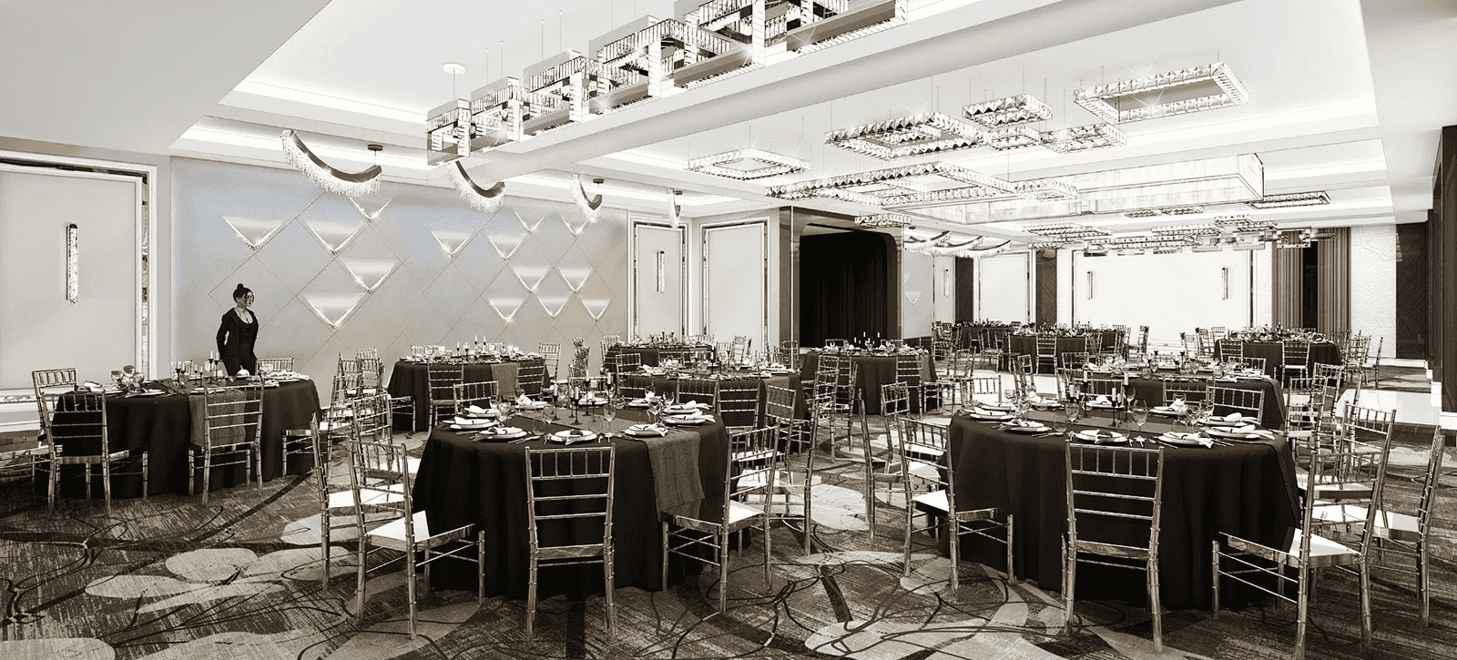 Elegant banquet hall set for an event, featuring black tablecloths, golden chairs, and modern chandeliers.
