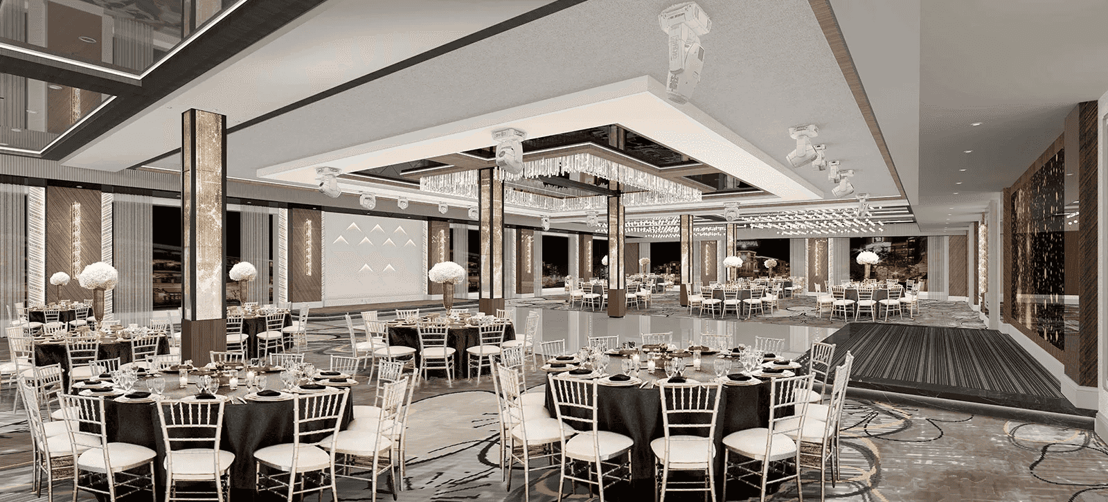 Elegant banquet hall with round tables, white chairs, black tablecloths, and floral centerpieces under modern chandeliers.
